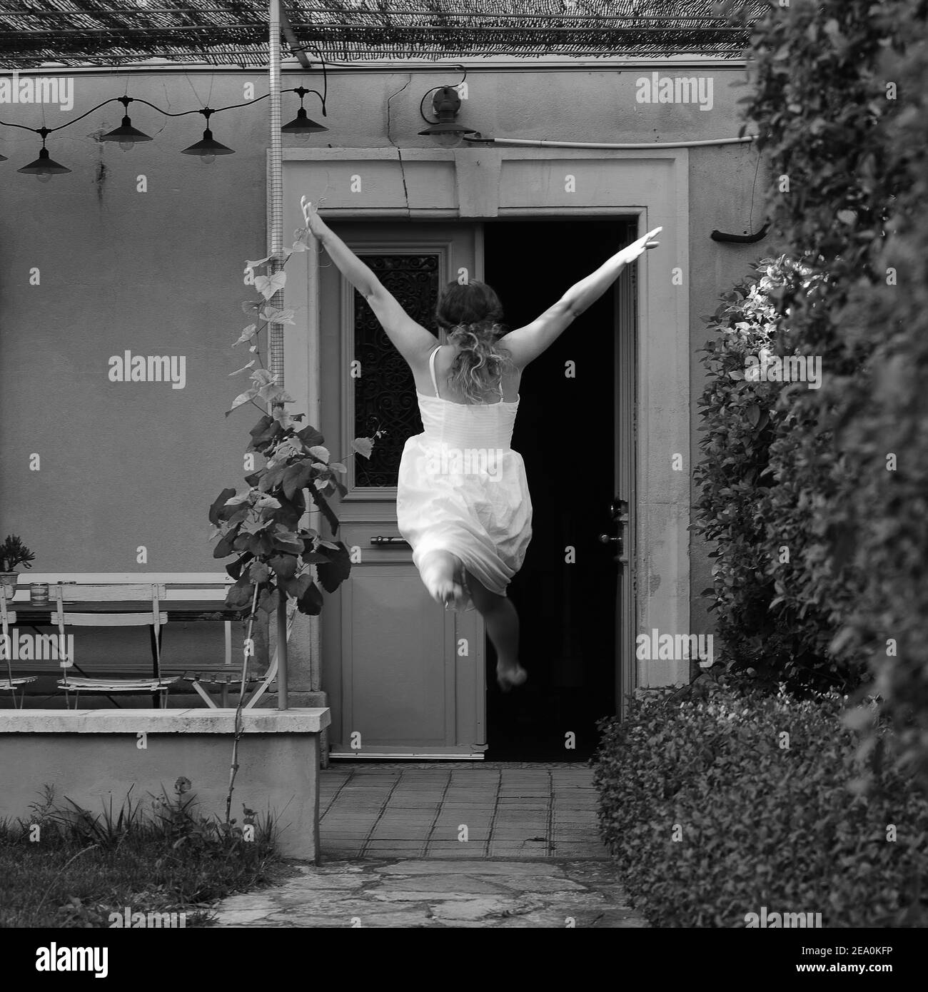 Girl jumping in a garden Stock Photo