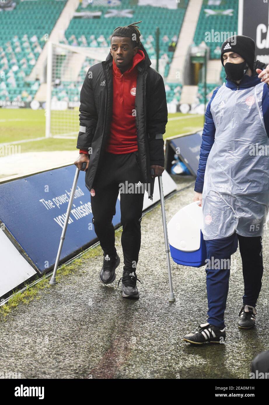 Easter Road Stadium.Edinburgh. Scotland.UK .6th Feb 21. Scottish Premiership match. Hibernian vs Aberdeen Greg Leigh (#5) of Aberdeen FC leaves the stadium on crutches after picking up a first half injury. Credit: eric mccowat/Alamy Live News Stock Photo