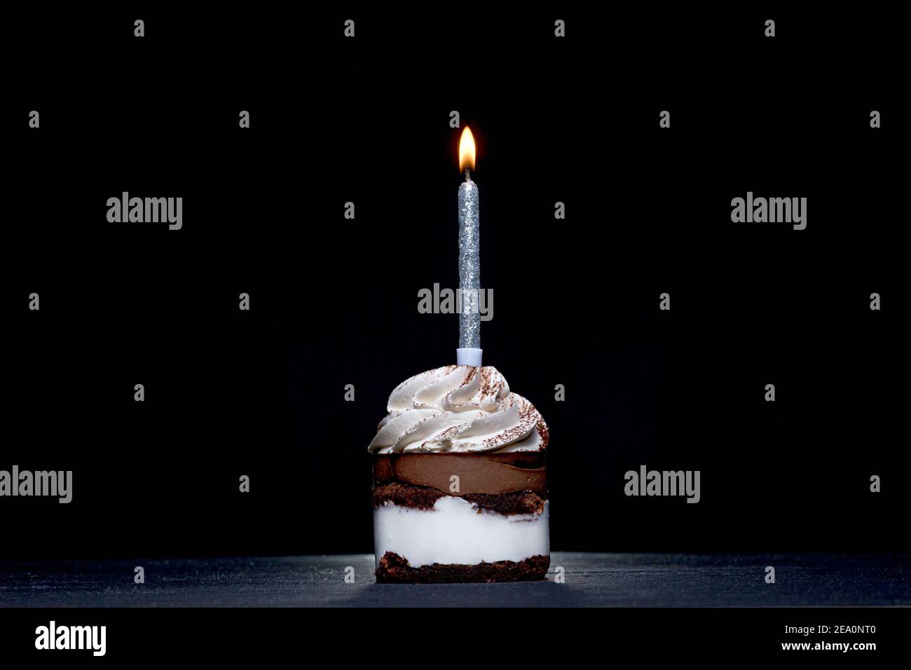 Birthday Cake with a candle on a black background Stock Photo - Alamy