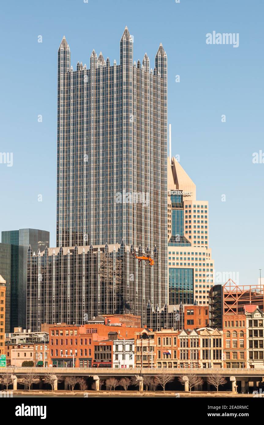 A sky crane helicopter delivering a air conditioning unit to the top of