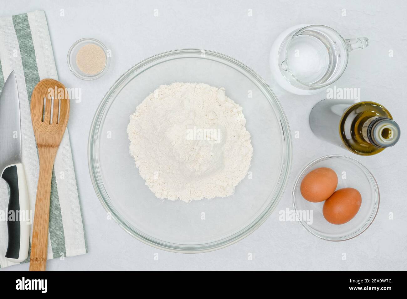 Mixing the water and oil into flour to make bread hires stock
