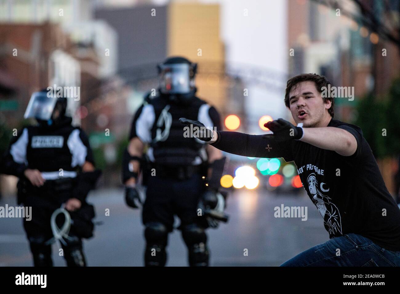 Protester tries to make peace between the Columbus Police and the main protesting group during the demonstration.Five days after the death of George Floyd at the hands of Minneapolis Police Officer Derek Chauvin Columbus, Ohio declared a state of emergency and imposed a curfew from 10pm to 6am to deal with the large scale protests happening in the city. The Ohio National Guard were called in at 3pm to help quell the protests and stop any rioting. National Guard and Riot officers pushed protesters north on High St. tear gassing and arresting protesters. Stock Photo