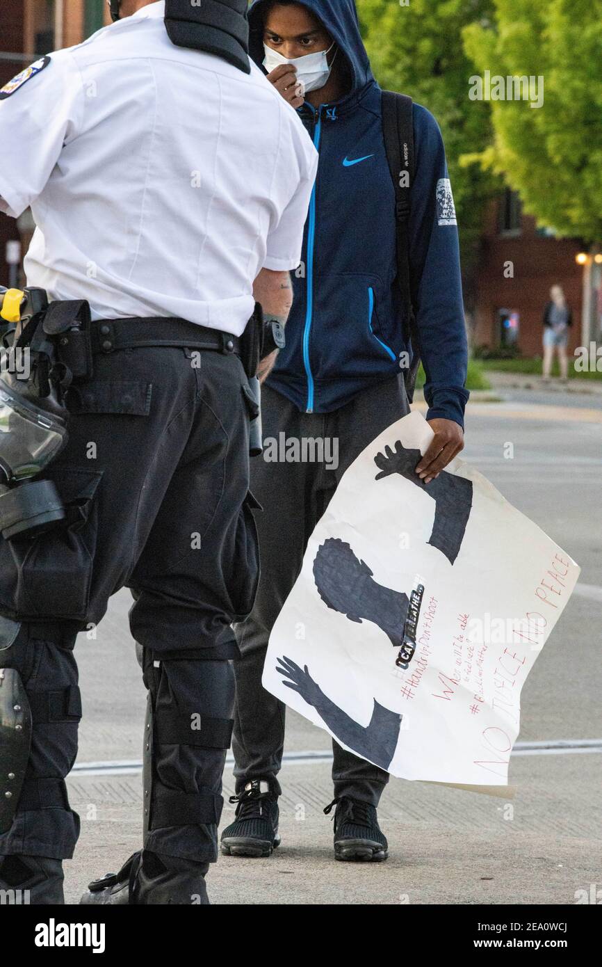 Lacarr Trent, 19, of Gahanna, Ohio talks with Columbus Police Officer during the demonstration.Five days after the death of George Floyd at the hands of Minneapolis Police Officer Derek Chauvin Columbus, Ohio declared a state of emergency and imposed a curfew from 10pm to 6am to deal with the large scale protests happening in the city. The Ohio National Guard were called in at 3pm to help quell the protests and stop any rioting. National Guard and Riot officers pushed protesters north on High St. tear gassing and arresting protesters. Stock Photo