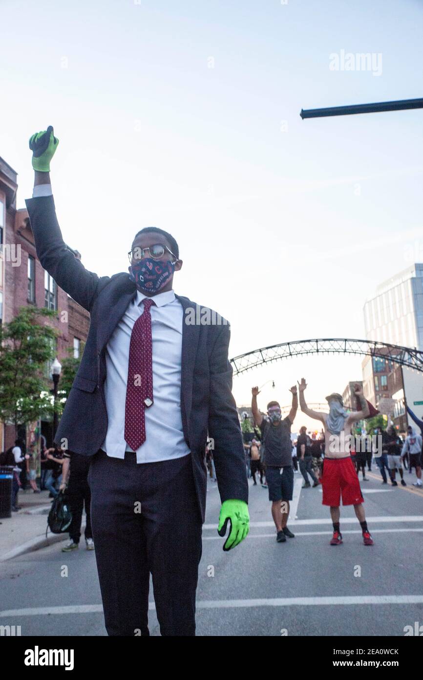 Revelation Sanders, 19, from Cleveland, Ohio, holds up his fist in solidarity with the Black Lives Matter movement.Five days after the death of George Floyd at the hands of Minneapolis Police Officer Derek Chauvin Columbus, Ohio declared a state of emergency and imposed a curfew from 10pm to 6am to deal with the large scale protests happening in the city. The Ohio National Guard were called in at 3pm to help quell the protests and stop any rioting. National Guard and Riot officers pushed protesters north on High St. tear gassing and arresting protesters. Stock Photo