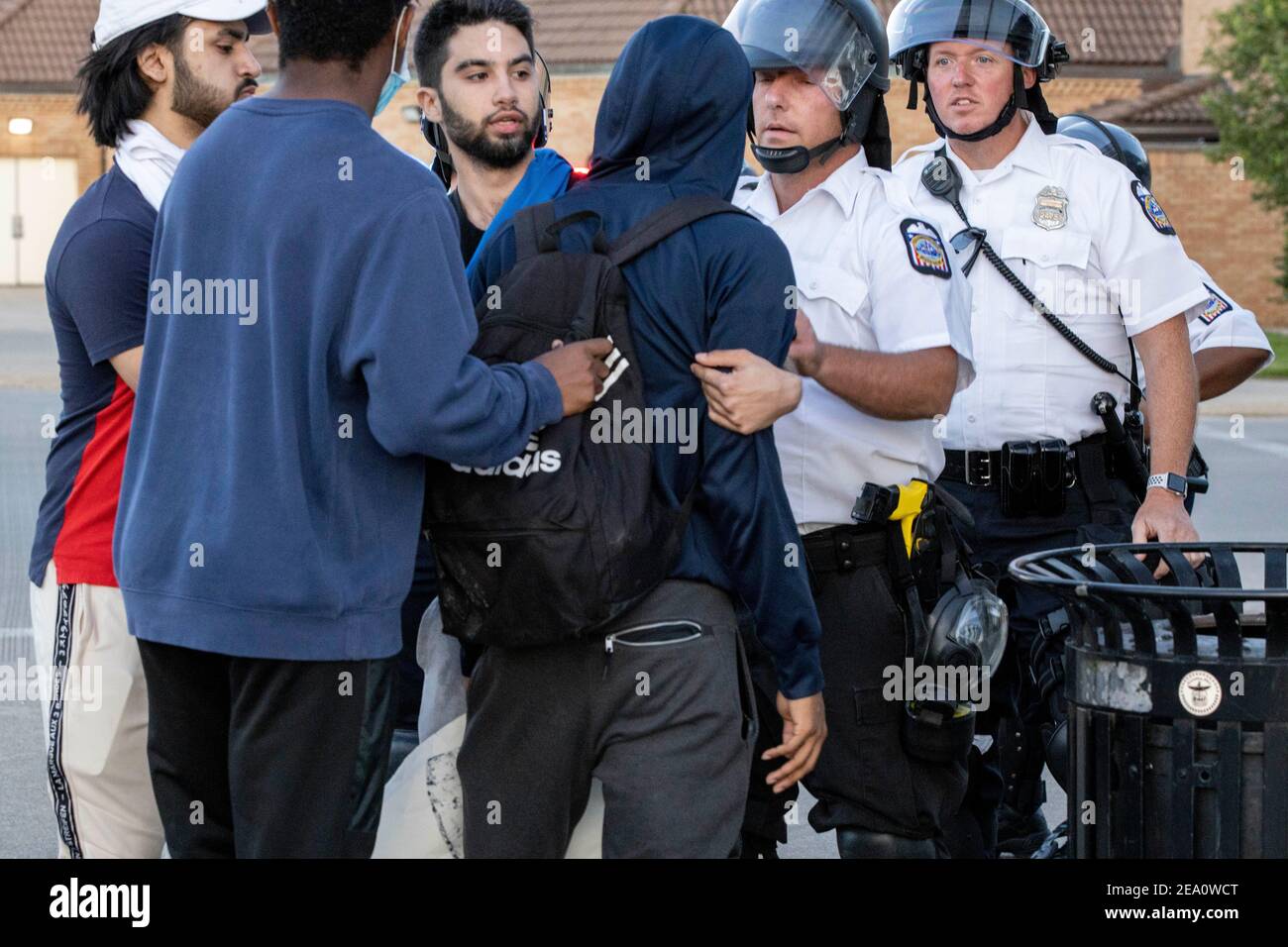Columbus Police Officer pushes Lacarr Trent, 19, of Gahanna, Ohio, during the demonstration.Five days after the death of George Floyd at the hands of Minneapolis Police Officer Derek Chauvin Columbus, Ohio declared a state of emergency and imposed a curfew from 10pm to 6am to deal with the large scale protests happening in the city. The Ohio National Guard were called in at 3pm to help quell the protests and stop any rioting. National Guard and Riot officers pushed protesters north on High St. tear gassing and arresting protesters. Stock Photo
