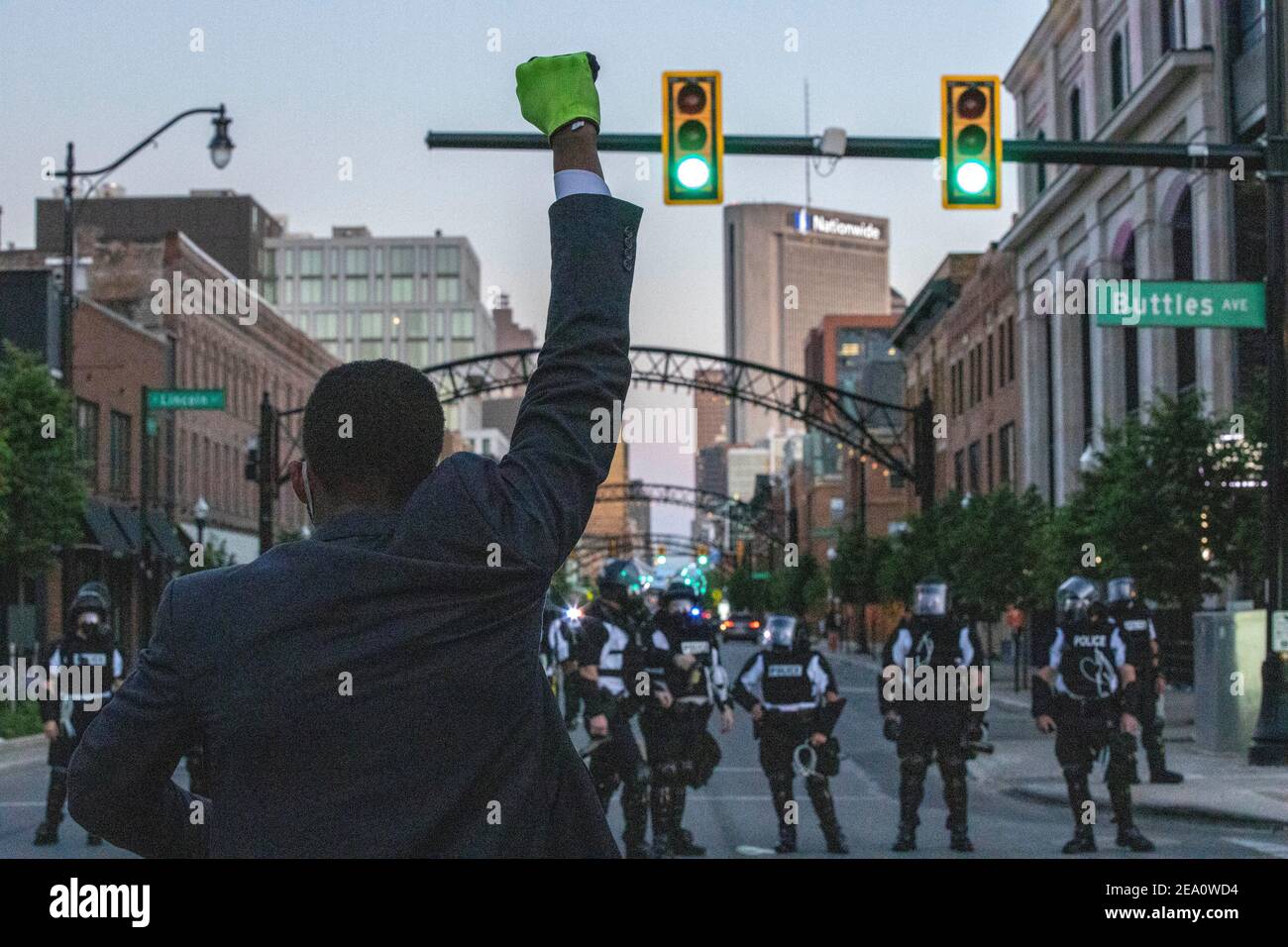 Revelation Sanders, 19, of Cleveland, Ohio holds up his fist in front of the police line during the demonstration.Five days after the death of George Floyd at the hands of Minneapolis Police Officer Derek Chauvin Columbus, Ohio declared a state of emergency and imposed a curfew from 10pm to 6am to deal with the large scale protests happening in the city. The Ohio National Guard were called in at 3pm to help quell the protests and stop any rioting. National Guard and Riot officers pushed protesters north on High St. tear gassing and arresting protesters. Stock Photo