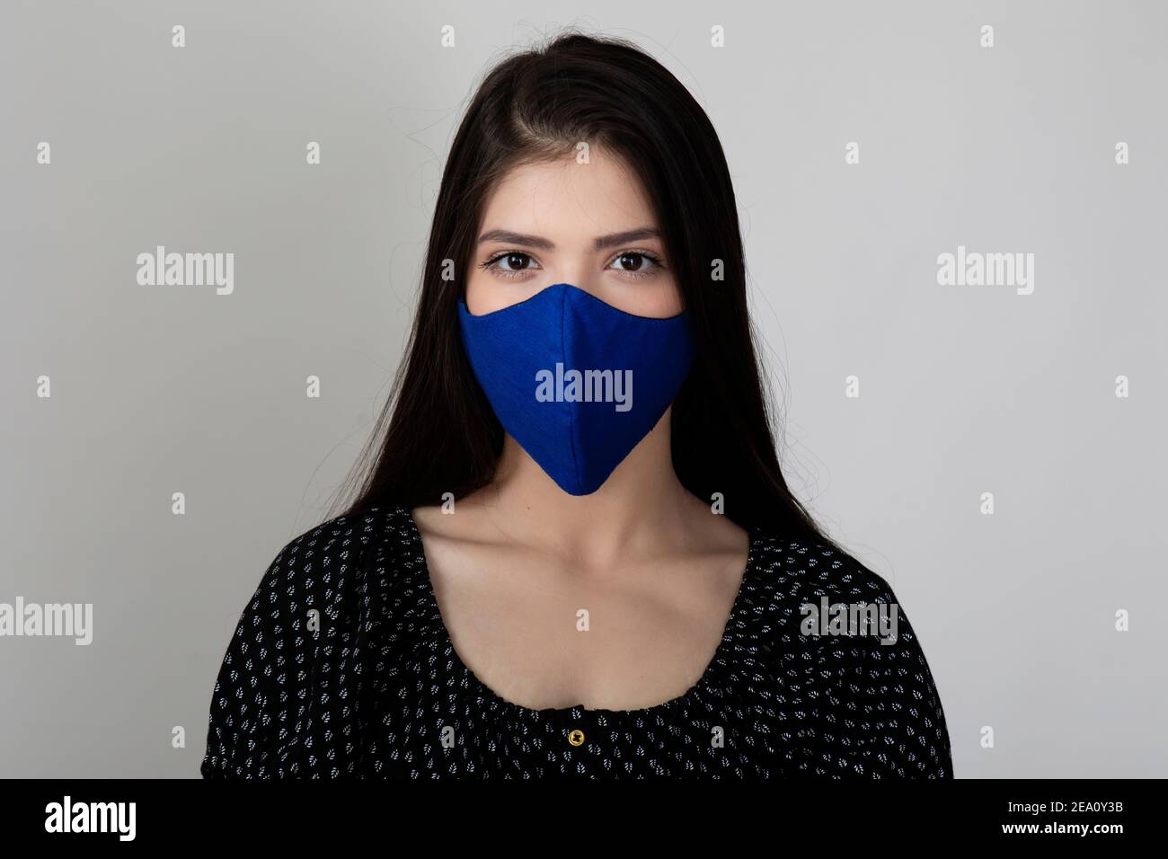Image of a pretty young girl wearing Covid 19 protection mask and ...