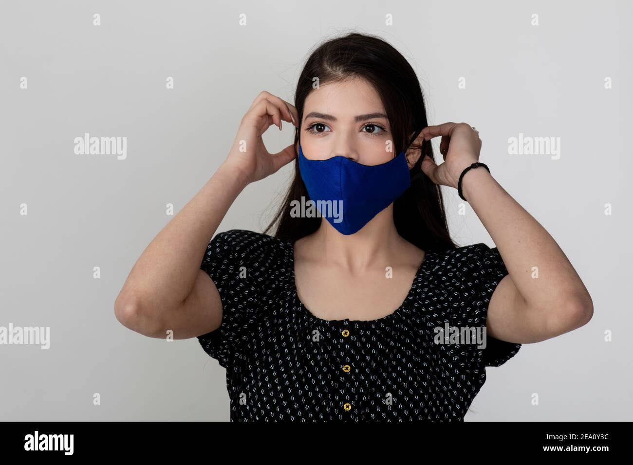 Image of a pretty young girl wearing Covid 19 protection mask and ...