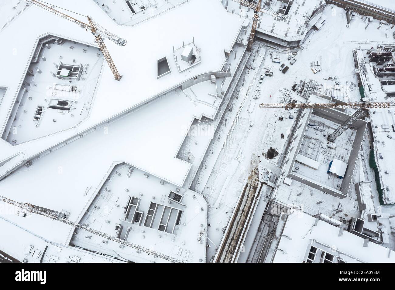 aerial top view of large construction site with cranes covered with snow Stock Photo