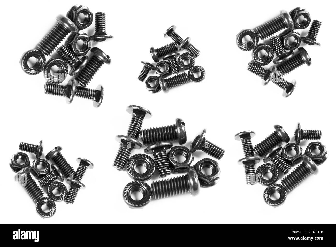 Black metal bolts and nuts  in a row. Black screw bolts and nuts isolated. Steel bolts and nuts pattern. Stock Photo