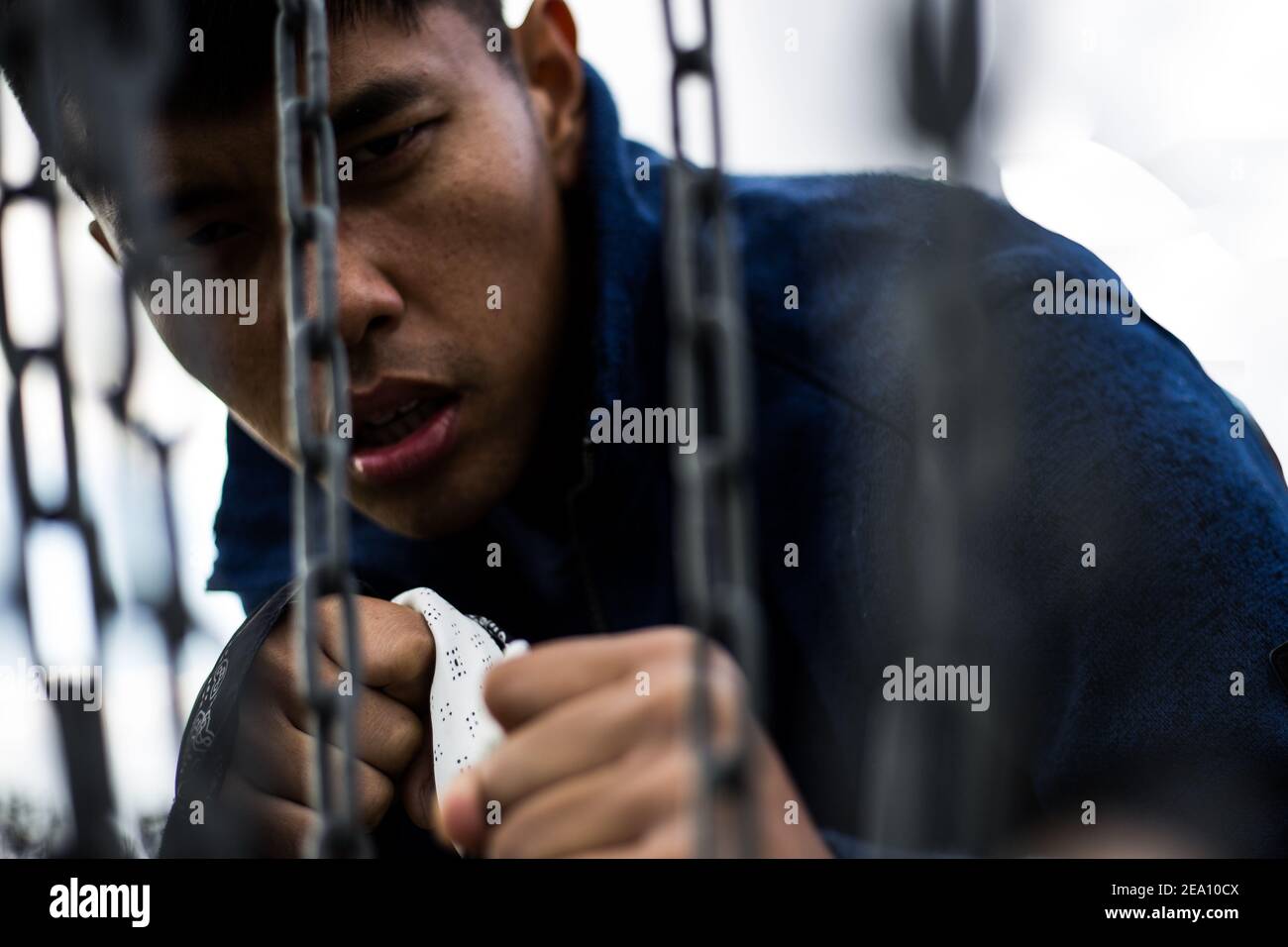 Man fighting behind chains Stock Photo Alamy