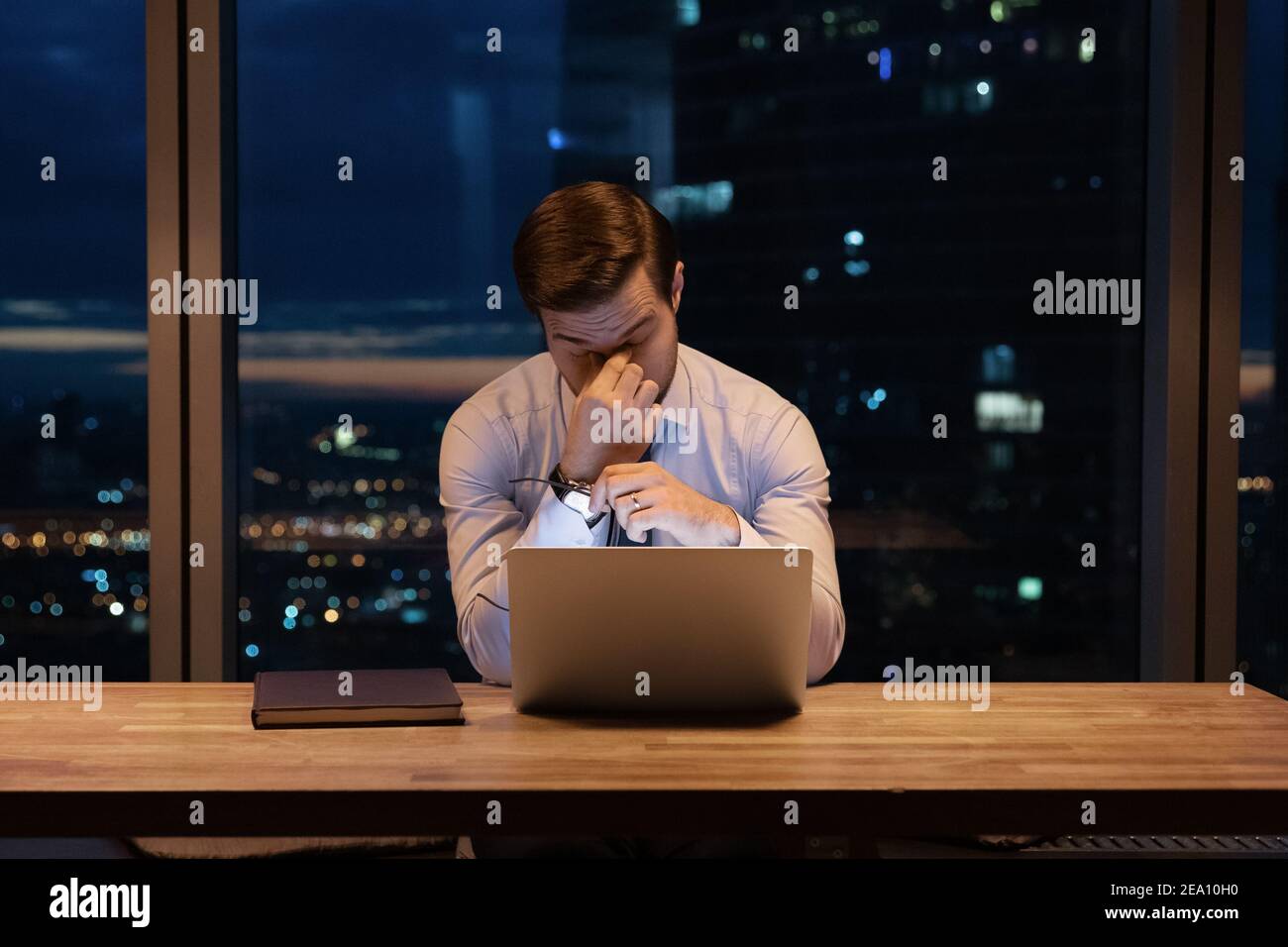 Busy young office employee suffer from chronic dry eye syndrome Stock Photo
