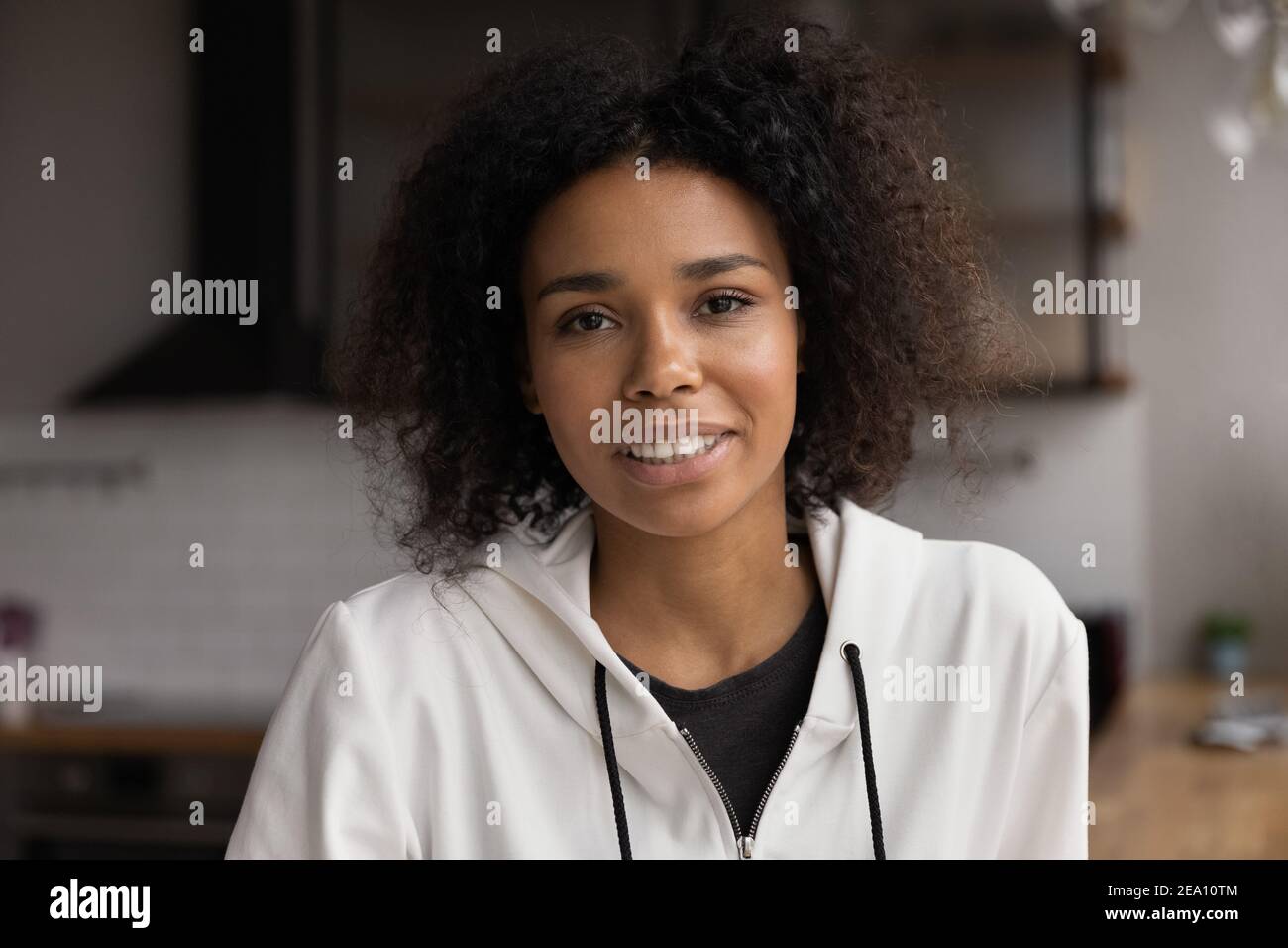 Smiling millennial african female looking at camera promoting healthy lifestyle Stock Photo