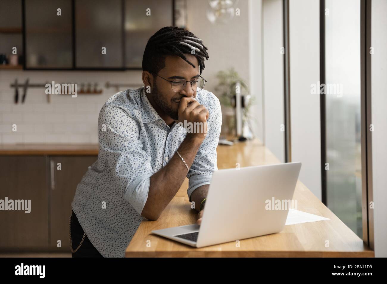 Smiling black guy freelancer read good message on laptop screen Stock Photo