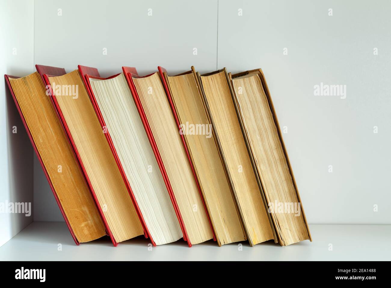 Old vintage books standing upright on a shelf Stock Photo Alamy