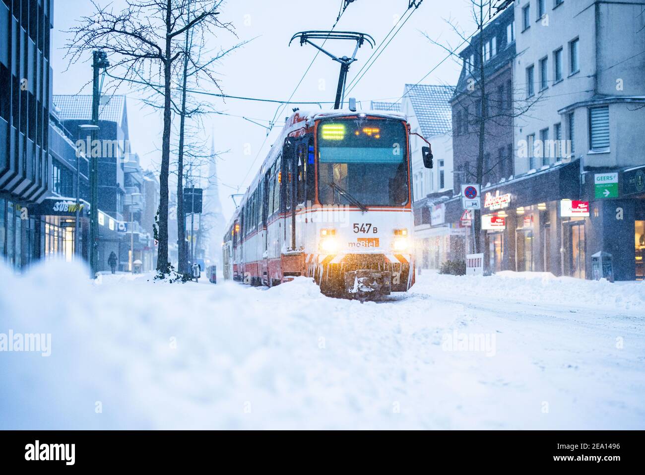 Bielefeld, Germany. 07th Feb, 2021. Single cones hang from a broken down tram in the early morning after a heavy snowfall. Credit: Marcel Kusch/dpa/Alamy Live News Stock Photo