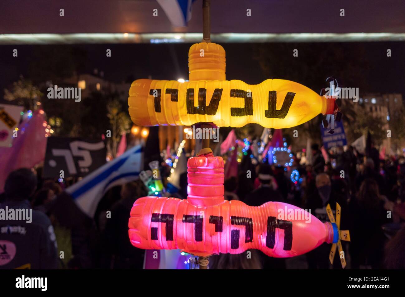 A protester holds mock submarines (In reference to the so-called submarine affair a massive alleged procurement bribery scandal) bearing the words 'Investigation Now' during a demonstration calling for Benjamin Netanyahu’s resignation citing his ongoing legal troubles in Jerusalem, Israel. Stock Photo