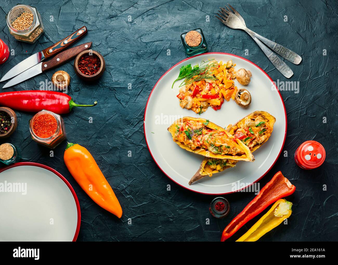 Baked yam with peppers,quinoa and mushrooms.Batata halves stuffed with vegetables Stock Photo