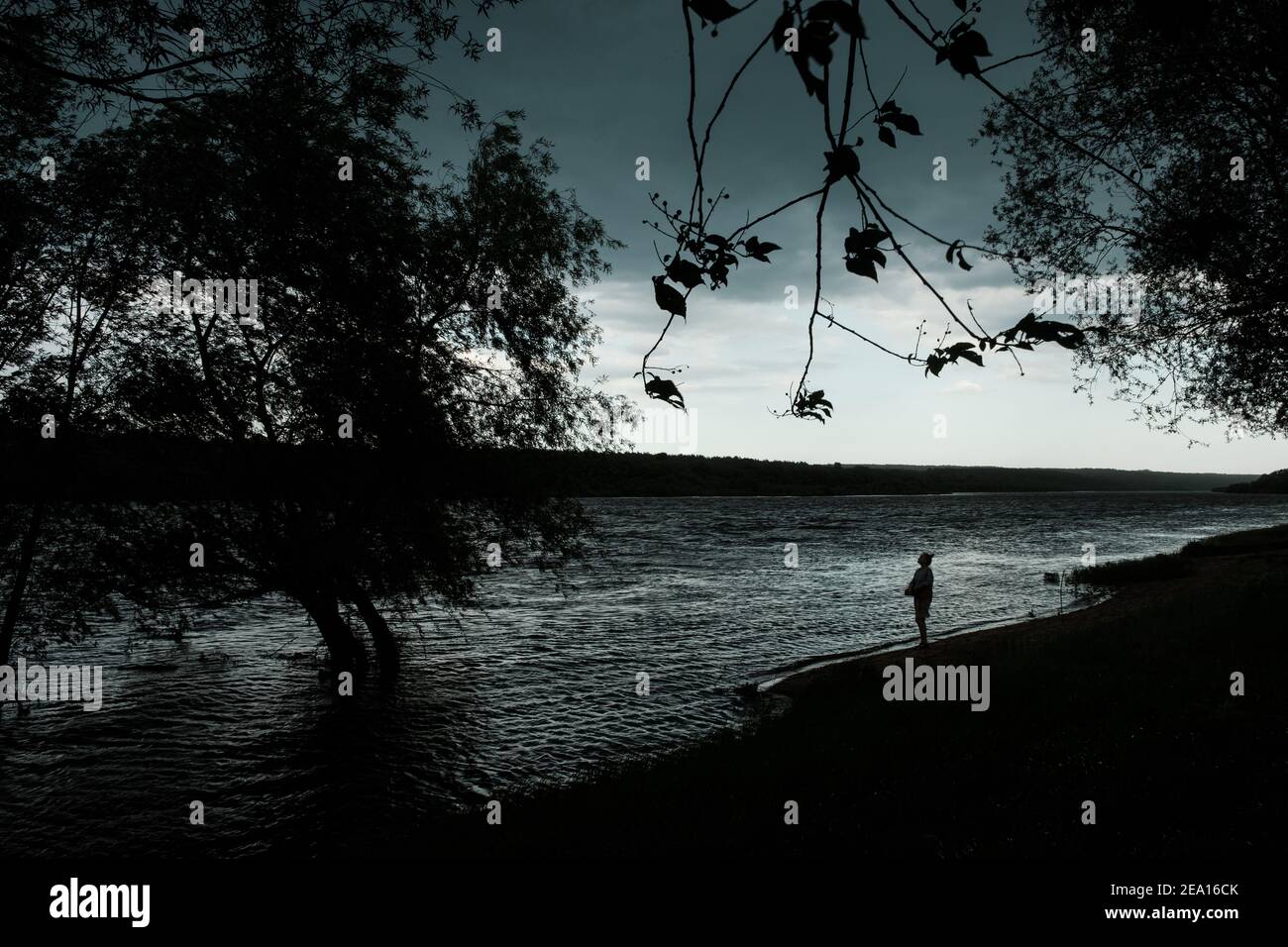 A girl stands on the bank during the flood of the Oka River between Tarusa and Serpukhov Stock Photo