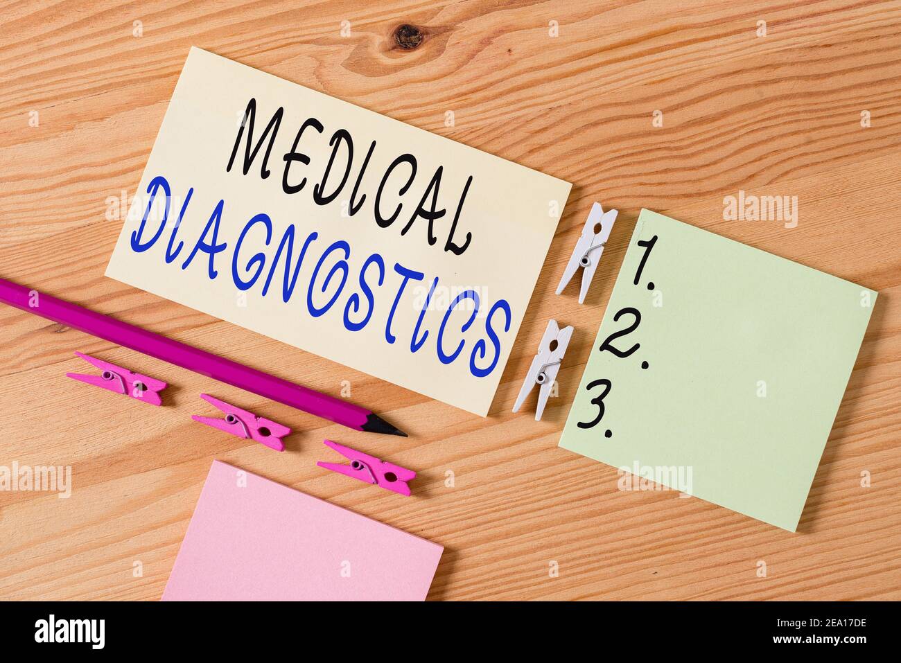 Writing note showing Medical Diagnostics. Business concept for act of identifying a disease from its signs and symptoms Colored clothespin papers empt Stock Photo