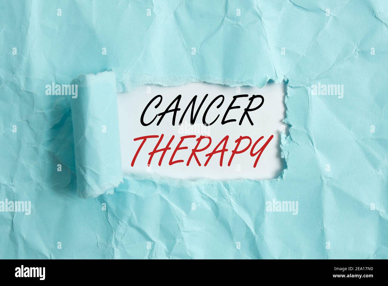 Text sign showing Cancer Therapy. Business photo showcasing the treatment of cancer in a patient often with chemotherapy Rolled ripped torn cardboard Stock Photo