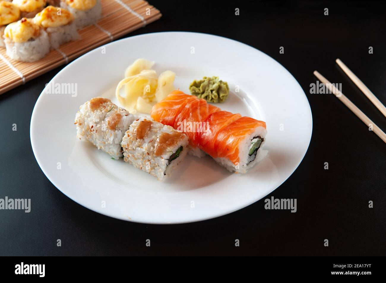 Japanese restaurant menu photo, seafood, national cuisine. Delicious sushi. Appetizing rolls served on white plate, flat lay Stock Photo