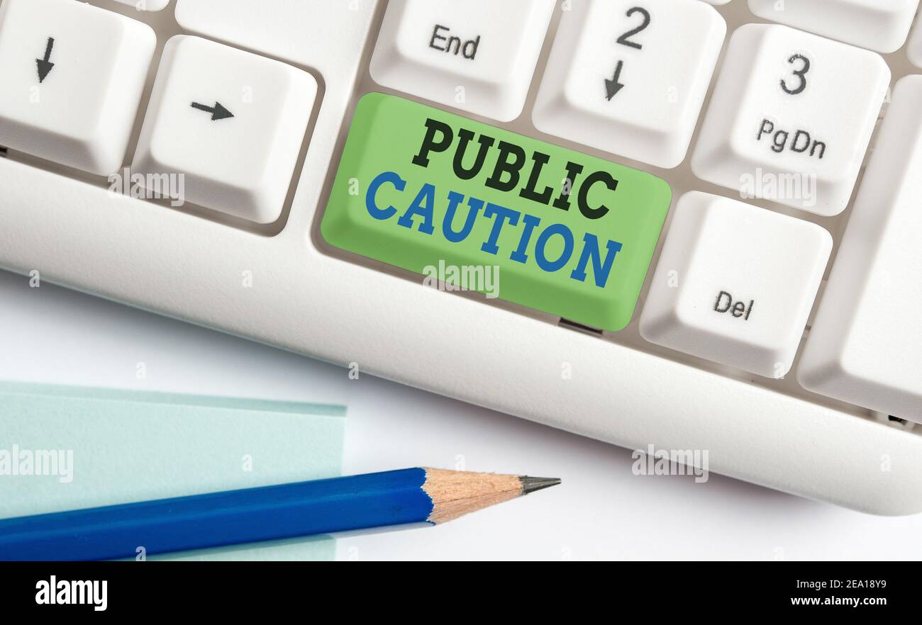 Word writing text Public Caution. Business photo showcasing formal warning given to the public to express a potential risk Different colored keyboard Stock Photo