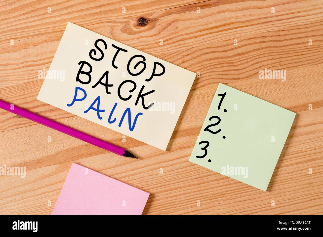 Text sign showing Stop Back Pain. Business photo text put an end on the pain felt in the low or upper back Colored clothespin papers empty reminder wo Stock Photo