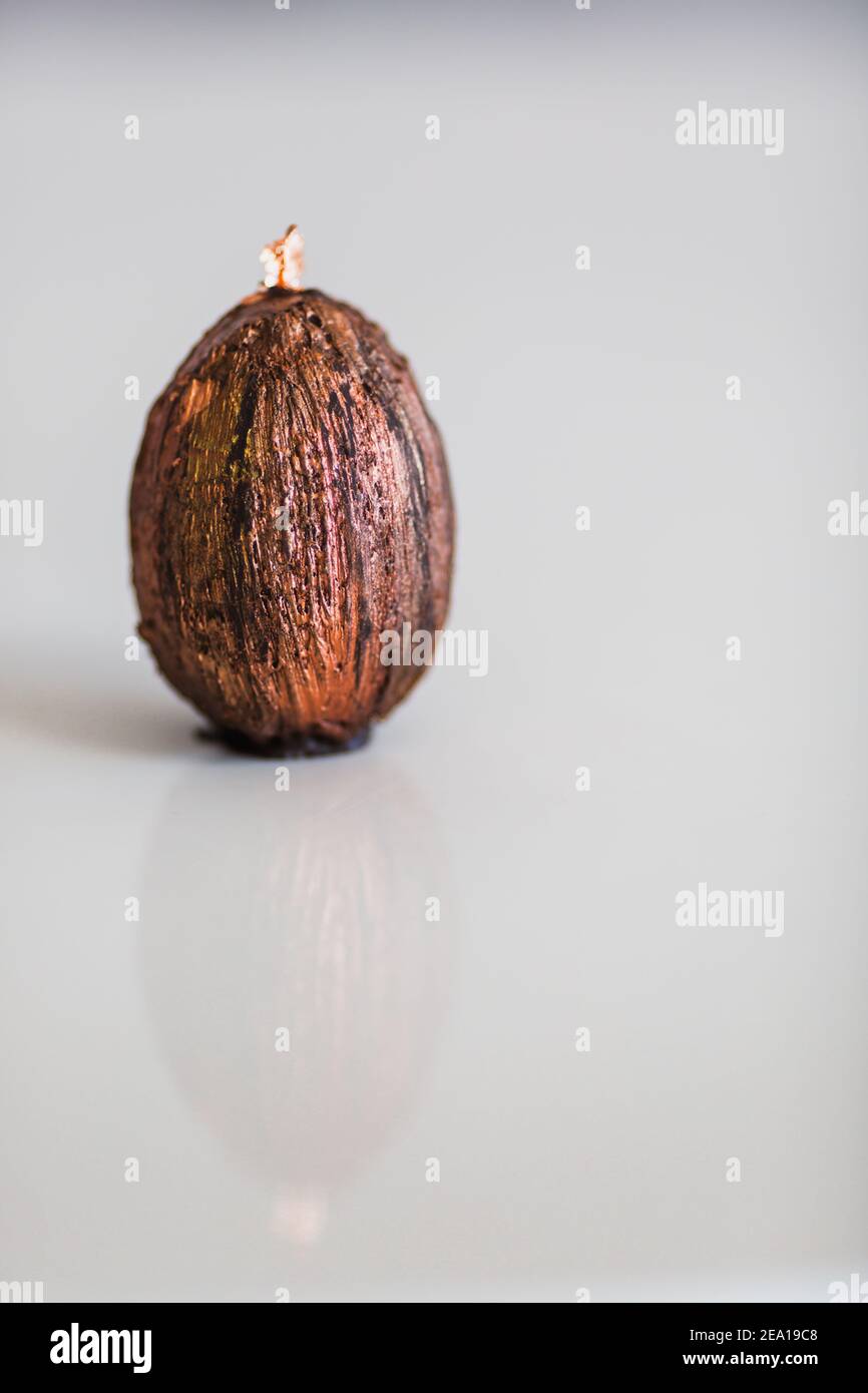 Handmade chocolate with gold easter egg. Close-up, copy space Stock Photo