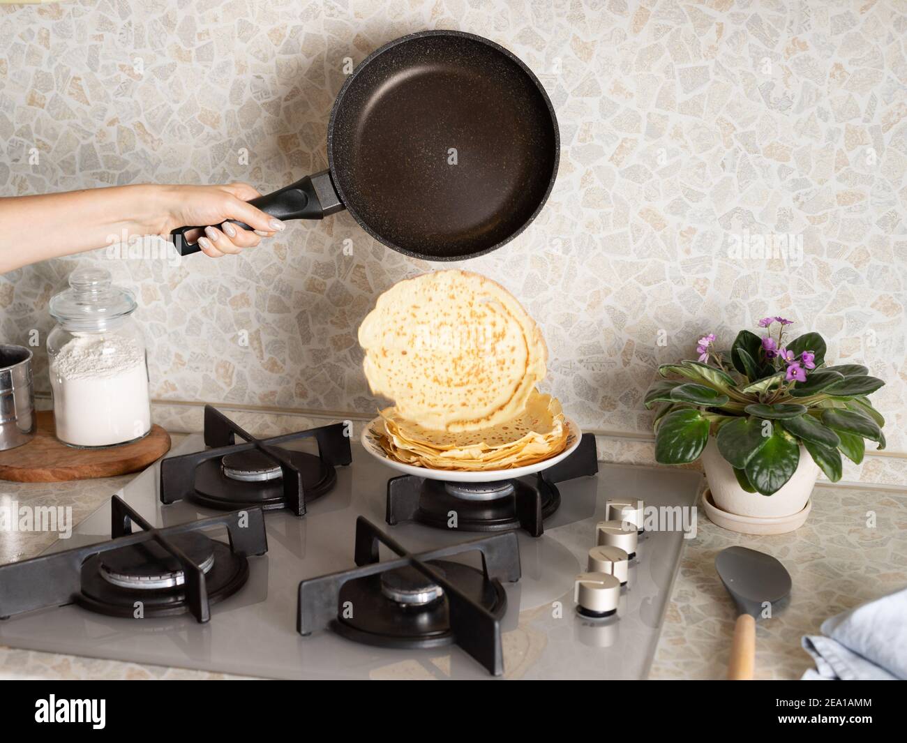 falling freshly baked pancake from hot frying pan Stock Photo Alamy