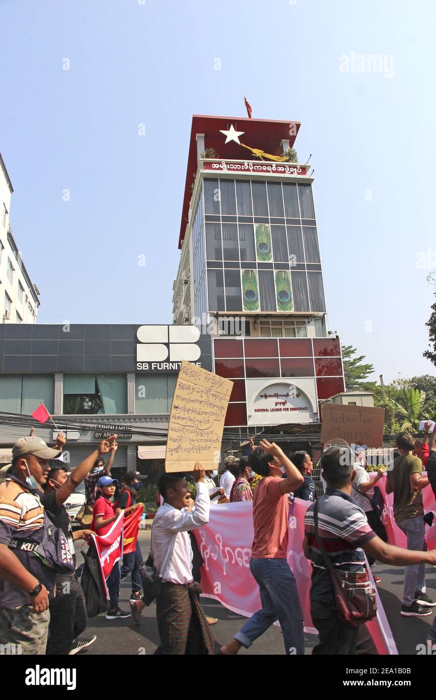 Yangon, Myanmar. 7th February, 2021. People march in front of the National League for Democracy headquarters building in Yangon, Myanmar, on Feb. 7, 2021, during a rally against the Feb. 1 military coup. (Kyodo)==Kyodo Photo via Credit: Newscom/Alamy Live News Stock Photo