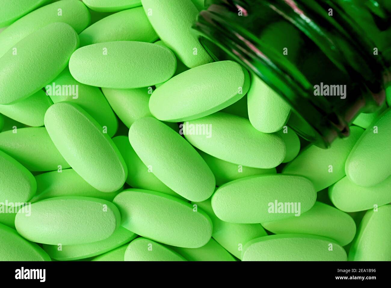 Top view of Lime green tablets poured from dark color glass bottle Stock Photo