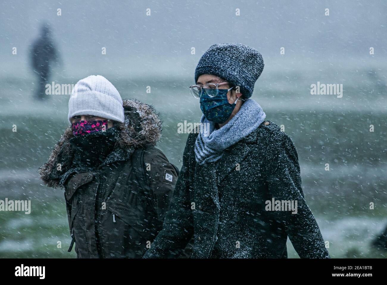 Wimbledon London Uk 7 February 21 People Wear Facemarks During A Snow Shower On Wimbledon Common As Storm Darcy Hits The Uk This Morning With Freezing Temperatures The Met Office Has Issued