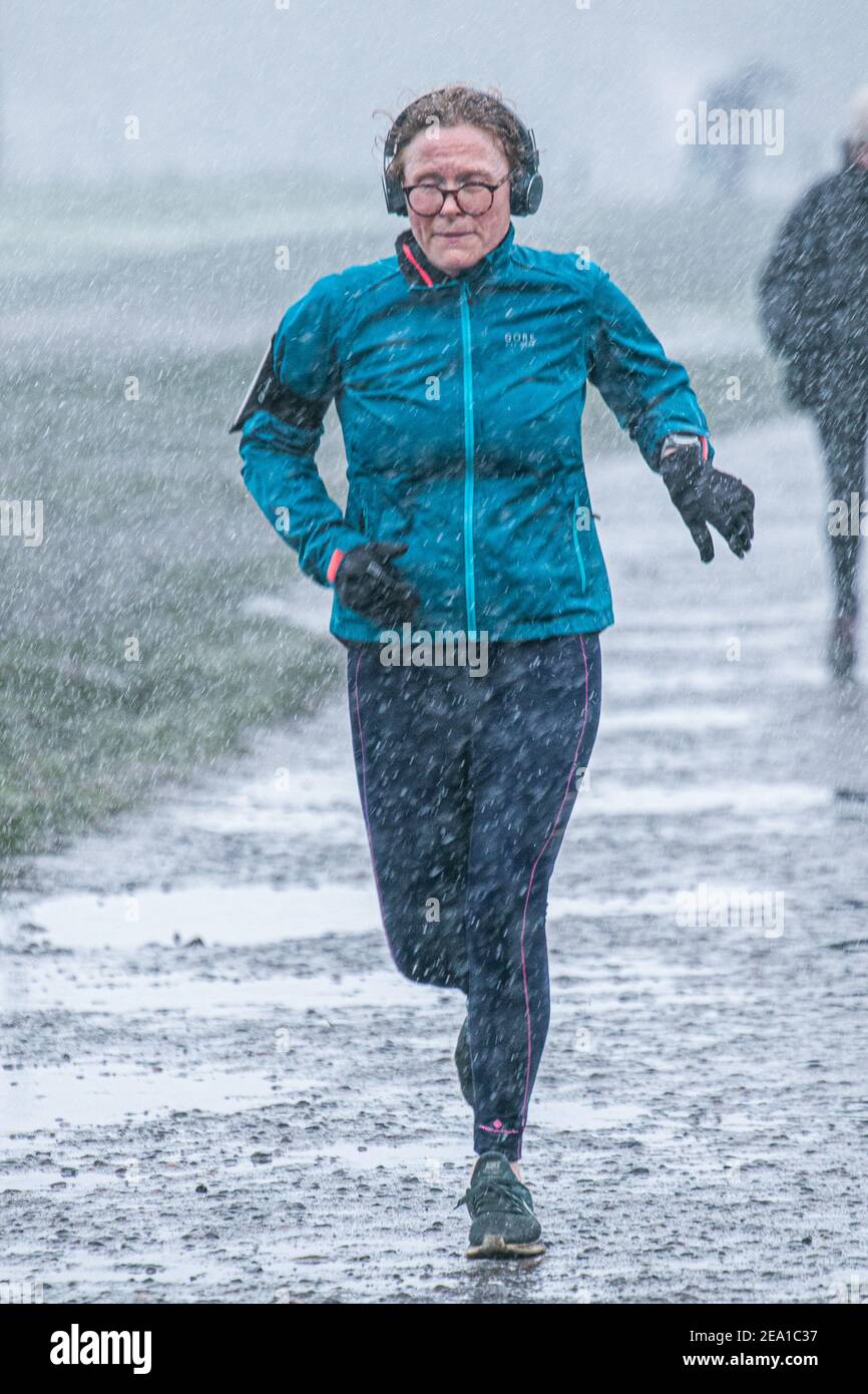 Wimbledon London Uk 7 February 21 A Jogger Runs During A Snow Shower On Wimbledon Common As Storm Darcy Hits The Uk This Morning With Freezing Temperatures The Met Office Has Issued Wimbledon London Uk 7 February 21 A Jogger Runs During A Snow Shower On Wimbledon Common As Storm Darcy Hits The Uk This Morning With Freezing Temperatures The Met Office Has Issued