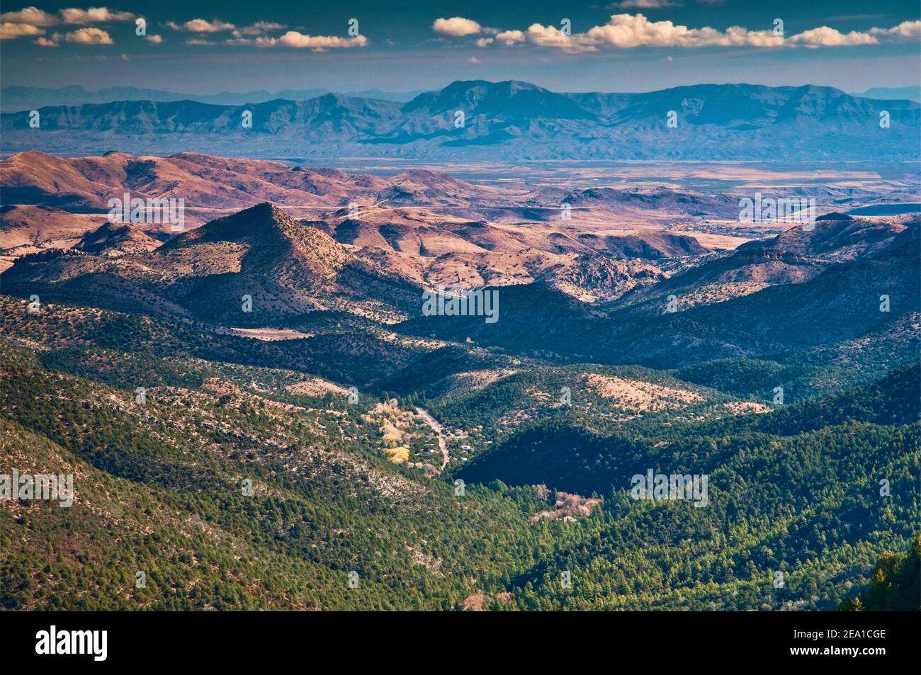 View east from Geronimo Trail at Emory Pass in Mimbres Mountains, town of Kingston in distance, Caballo Mountains in far distance, New Mexico, USA Stock Photo