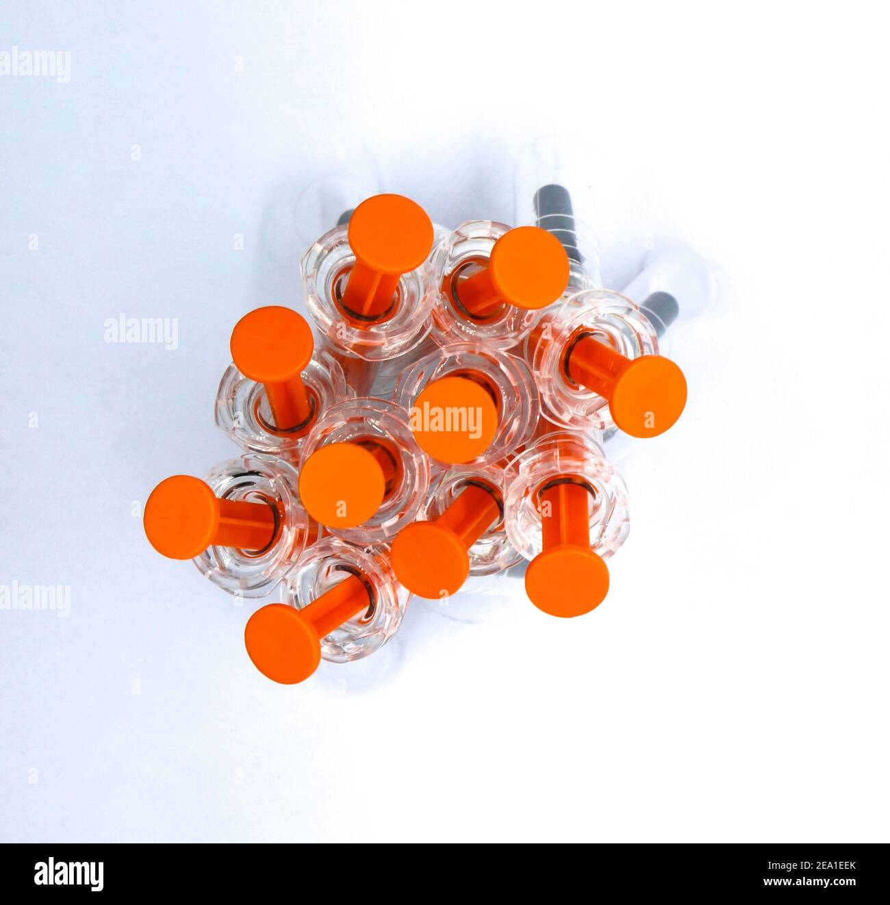 End on view of Transparent black and orange used plastic syringes pre