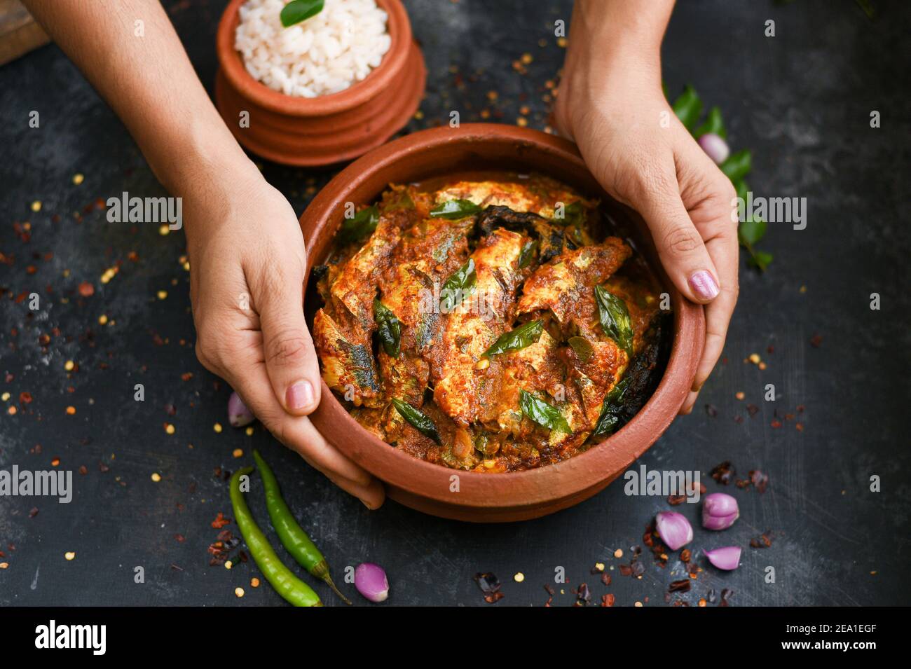 Top view Sardine fish curry spicy Woman hand take Kerala fish curry