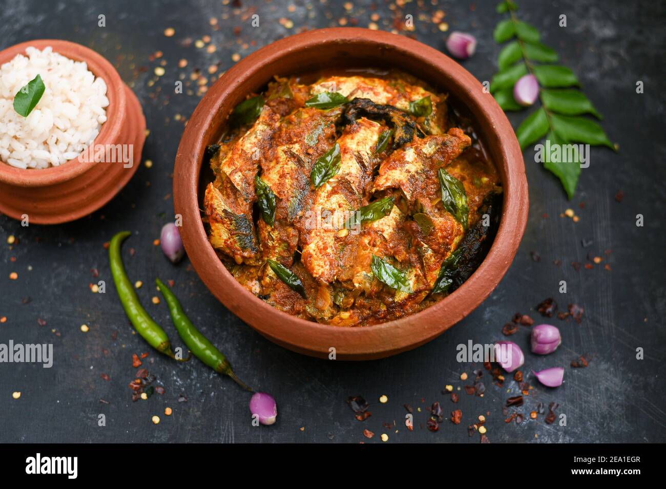 Top view Sardine fish curry spicy Woman hand take Kerala fish curry