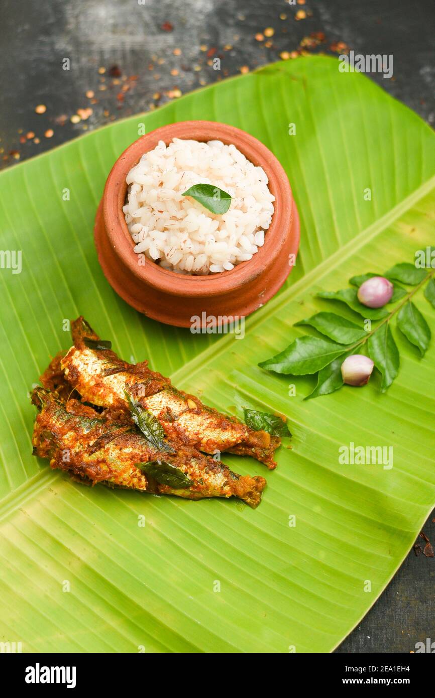 Top view Sardine fish curry spicy Woman hand take Kerala fish curry