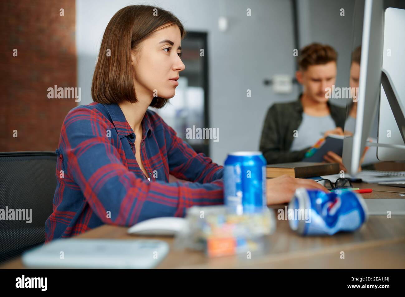 Focused IT specialist works on computer in office Stock Photo