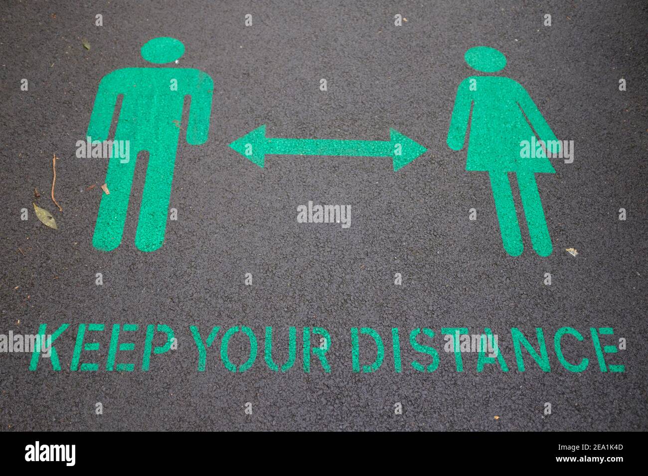 LONDON - 23RD JANUARY 2021: Green keep your distance sign painted onto ...