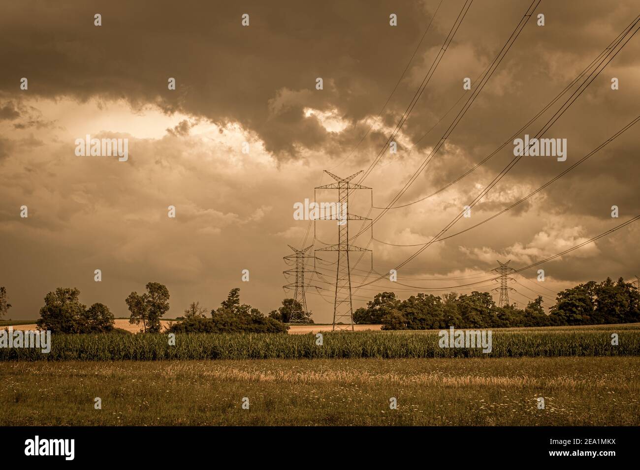 A landscape with a transmission tower under a cloudy sky Stock Photo ...