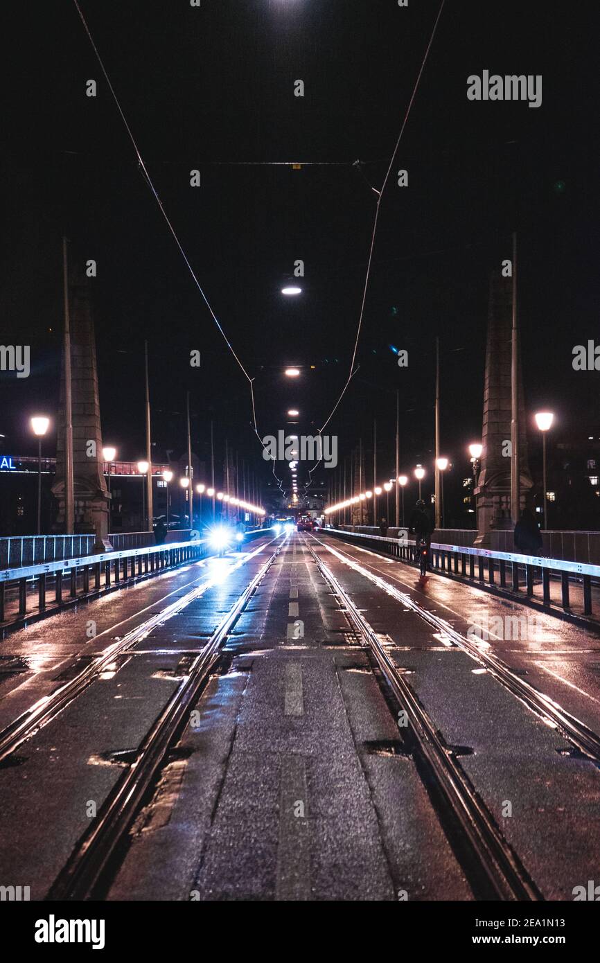 A night city road illuminated with street lights on both sides Stock