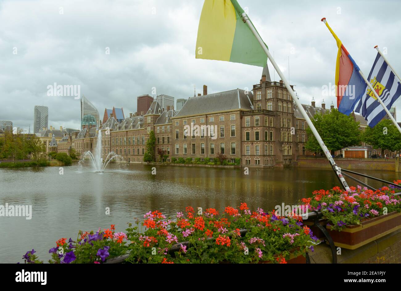 The Binnenhof castle on a cloudy day, next to the Hofvijver lake in the city center of The Hague (Den Haag). The Dutch parliament building is located Stock Photo