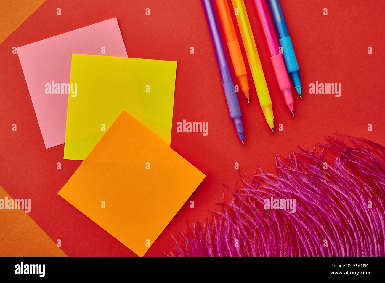 Pens and notepads closeup, red background Stock Photo