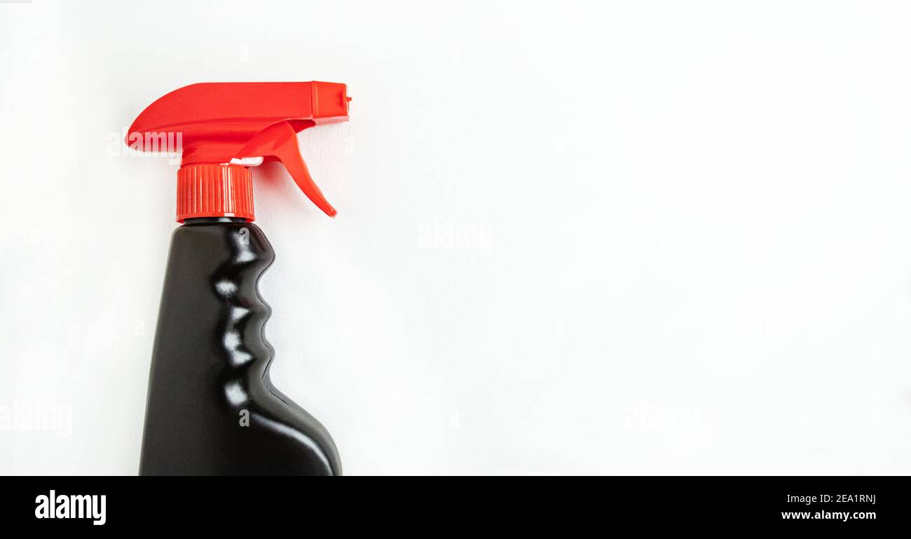 Concept of a cleaning company or household cleaning. Black bottle of household spray on a boule background with place for text Stock Photo
