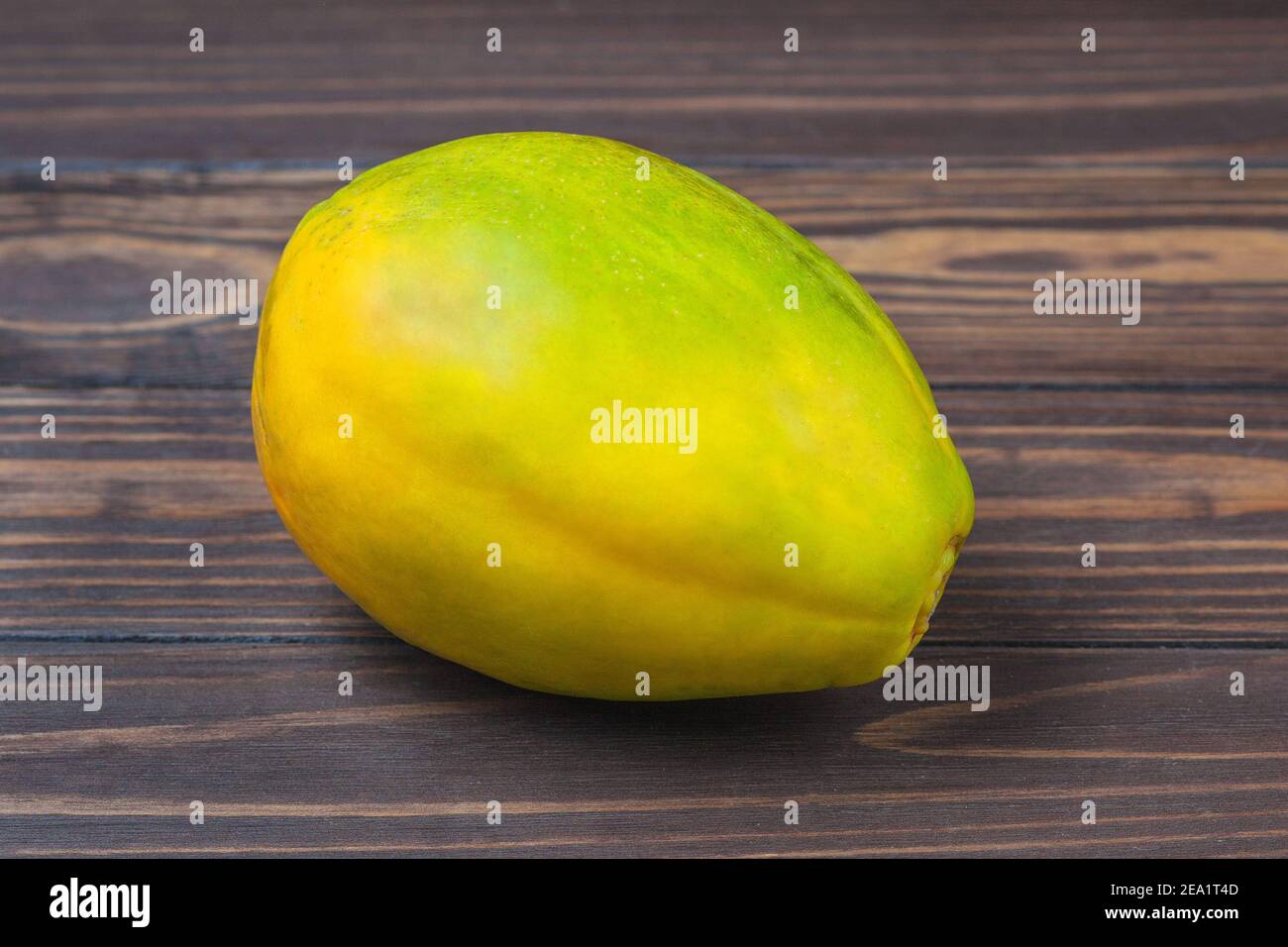 Ripe papaya fruit lie on a background of wooden boards. High quality photo Stock Photo