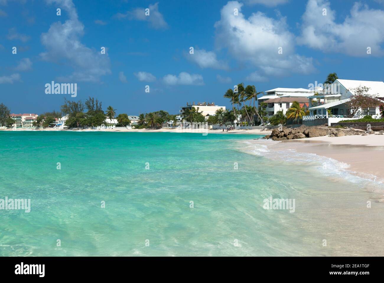 Worthing beach in Barbados. Beach with palm trees on ocean. Background  white houses  Worthing beach bungalow. Beach with palm trees on ocean Stock Photo