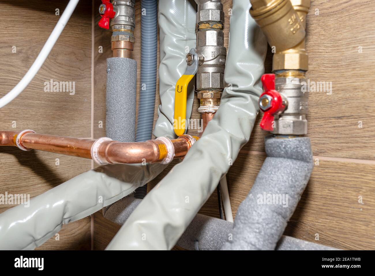 Natural gas valves and pipes in a modern home boiler room with ceramic