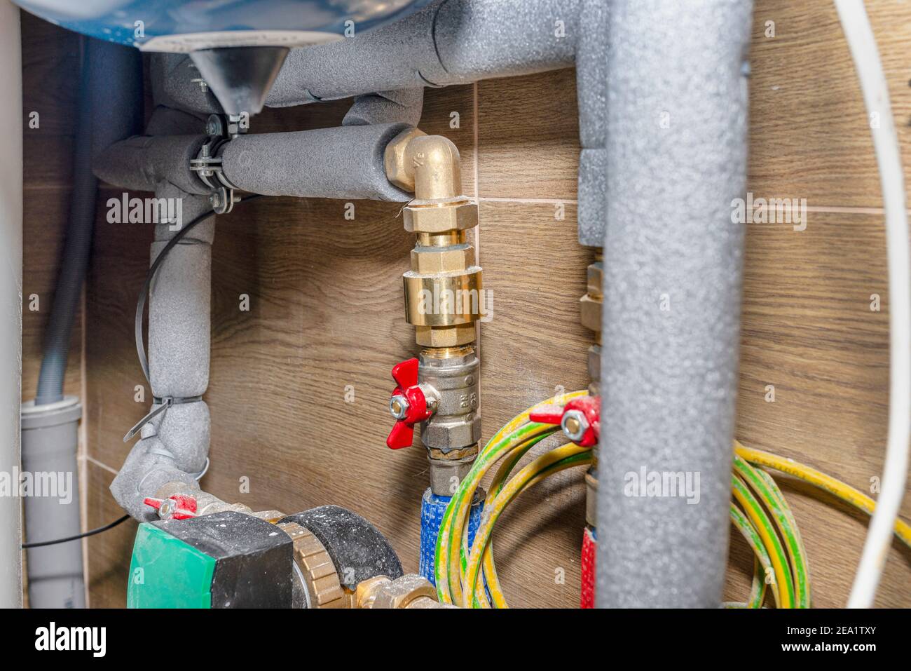 Natural gas valves and pipes in a modern home boiler room with ceramic